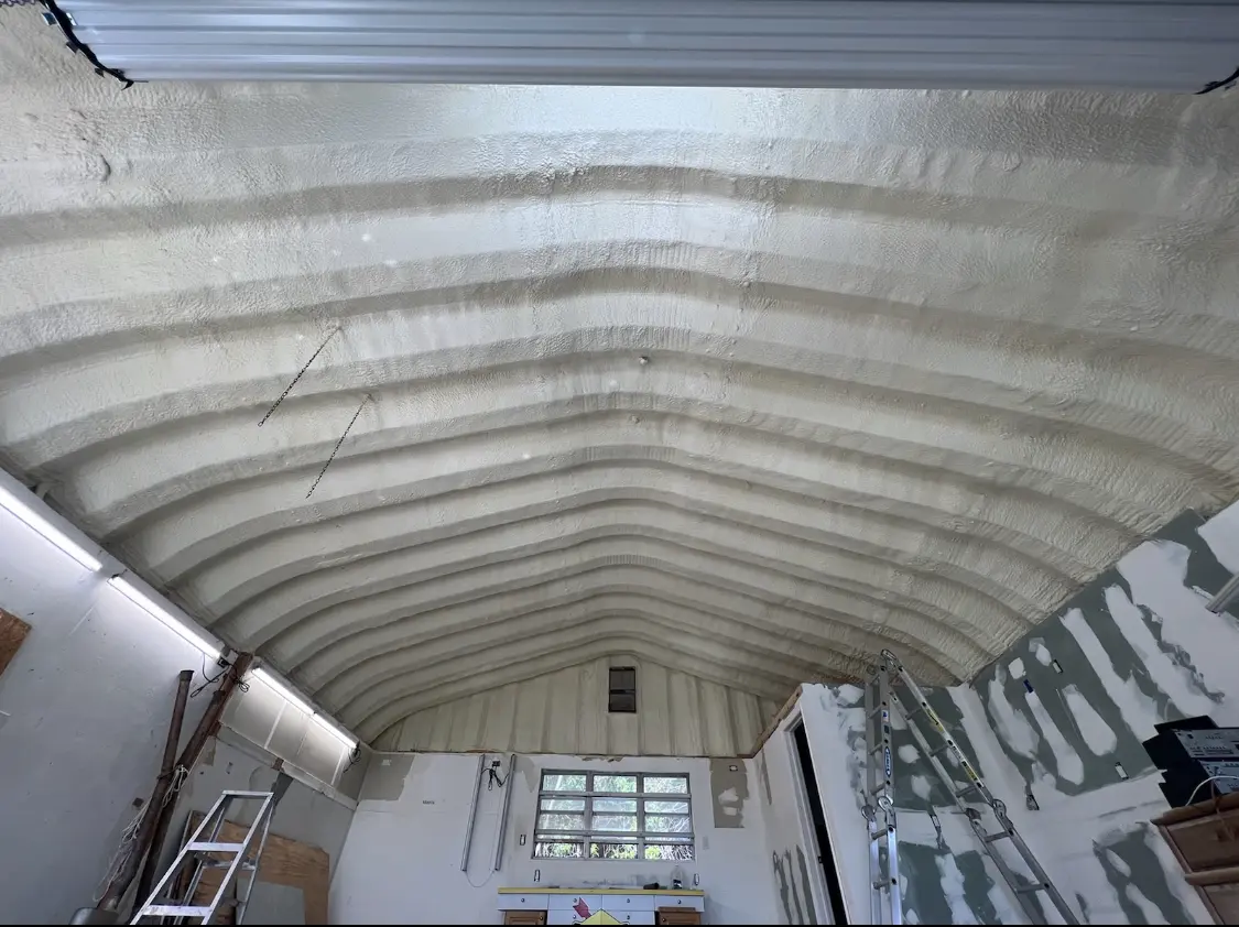 Spray polyurethane foam applied to the underside of a metal roof deck in Estelle